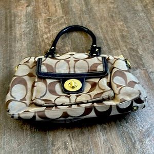 Tan and brown Coach purse with purple liner